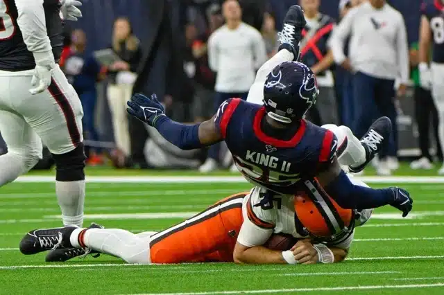 Houston Texans cornerback Desmond King II helicopters over the top of Cleveland Browns quarterback Joe Flacco