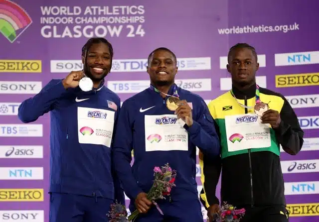 Gold medalist Christian Coleman (C) of the United States, silver medalist Noah Lyles (L) of the United States and bronze medalist Ackeem Blake of Jamaica pose during the awarding ceremony for the men s 60 meters event at the 2024 World Athletics Indoor Championships in Glasgow