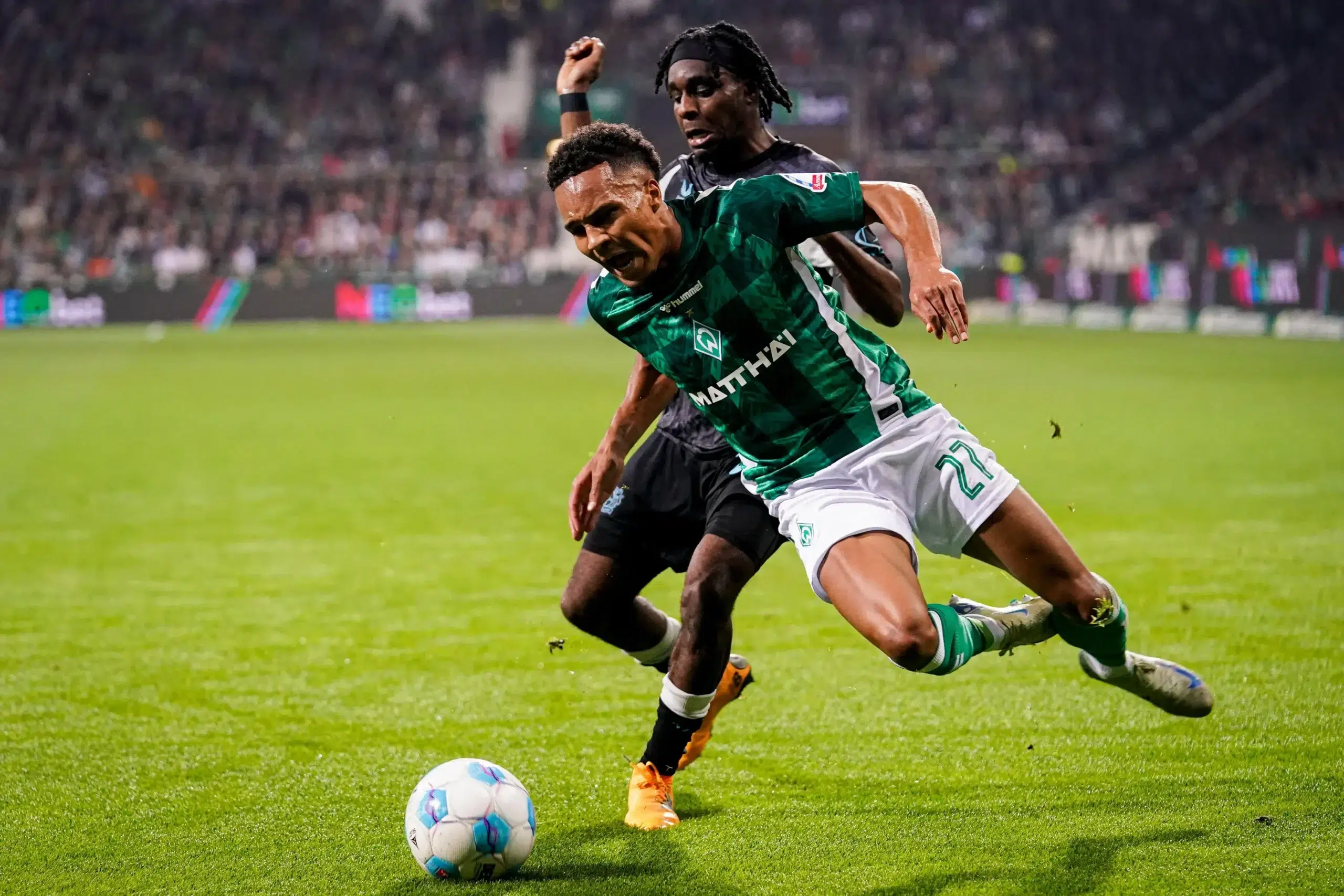 Felix Agu of SV Werder Bremen battles for possession with Jeremie Frimpong of Bayer 04 Leverkusen