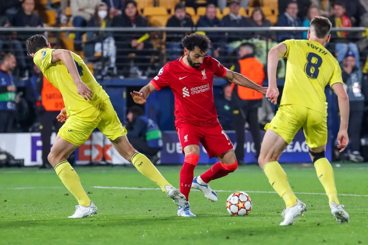 Mohamed Salah playing the ball between Pau Torres and Juan Foyth during the UEFA Champions League.