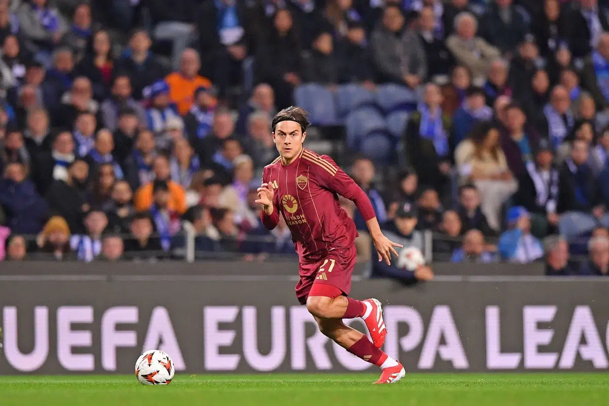 Paulo Dybala runs with the ball during a match between Porto and Roma at Dragao Stadium.