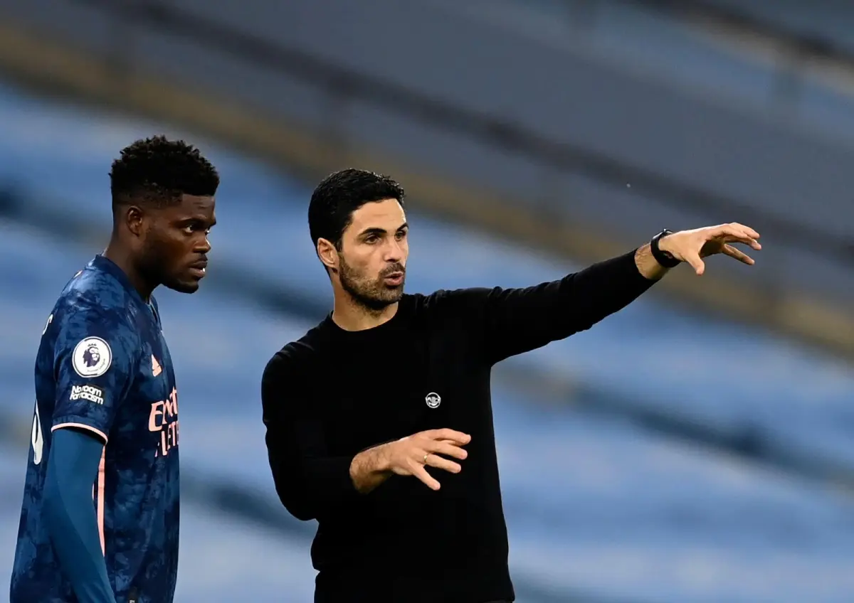 Arsenal's manager Mikel Arteta, right, gives instructions to Arsenal's Thomas Partey during the English Premier League soccer match between Manchester City and Arsenal at the Etihad stadium in Manchester