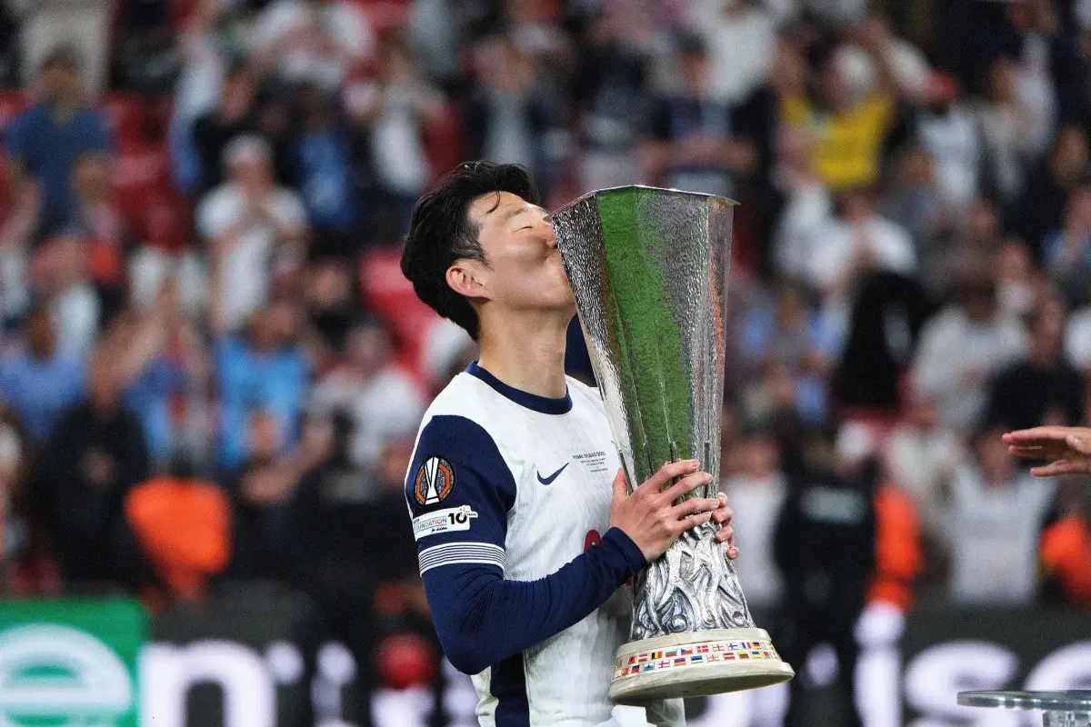 Heung-min Son, captain of Tottenham Hotspur, kisses the UEFA Europa League trophy in Tottenham Hotspur vs Manchester United match