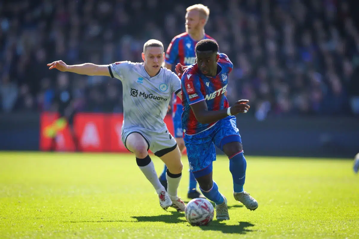 Millwall's Casper De Norre, left, challenges for the ball with Crystal Palace's Marc Guehi during the English FA Cup soccer match