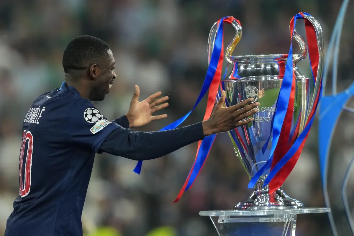 Ousmane Dembélé of Paris Saint-Germain holds the trophy during the awards ceremony following the UEFA Champions League final match.