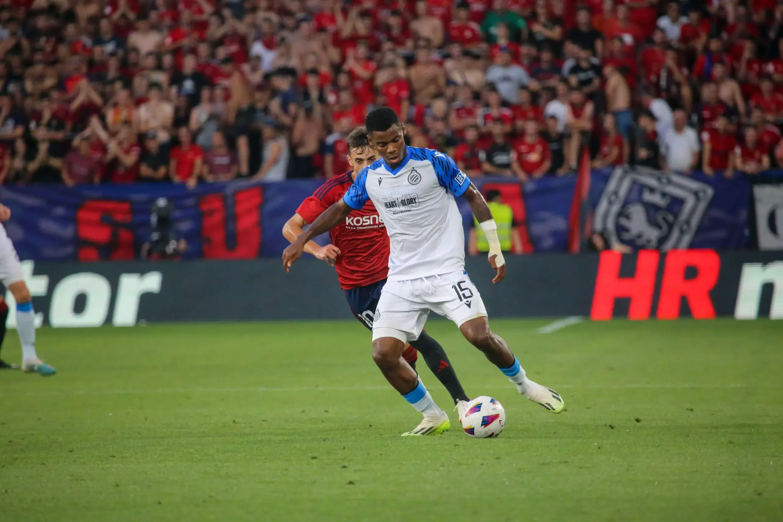 Club Brugge's player Raphael Onyedika (15) protects the ball from a rival during the first leg of the previous round of the UEFA Europa Conference League