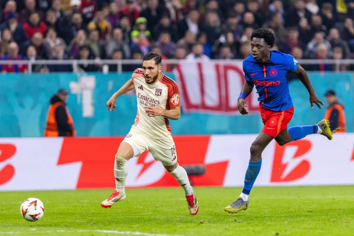 Rayan Cherki of Lyon and Malcom Edjouma of FCSB in action during the UEFA Europa League, 2025