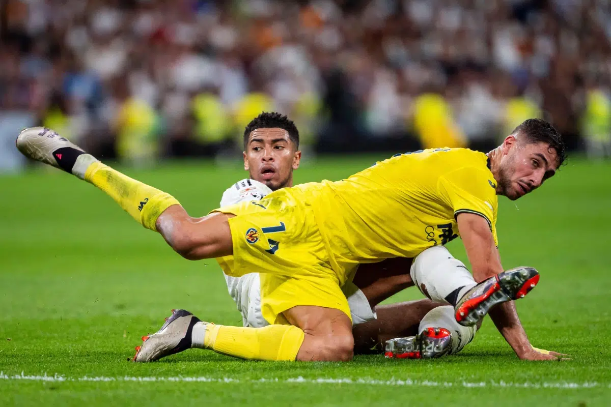Jude Bellingham of Real Madrid CF in action against Santi Comesana of Villarreal CF during the La Liga EA Sports 2024/25 football match