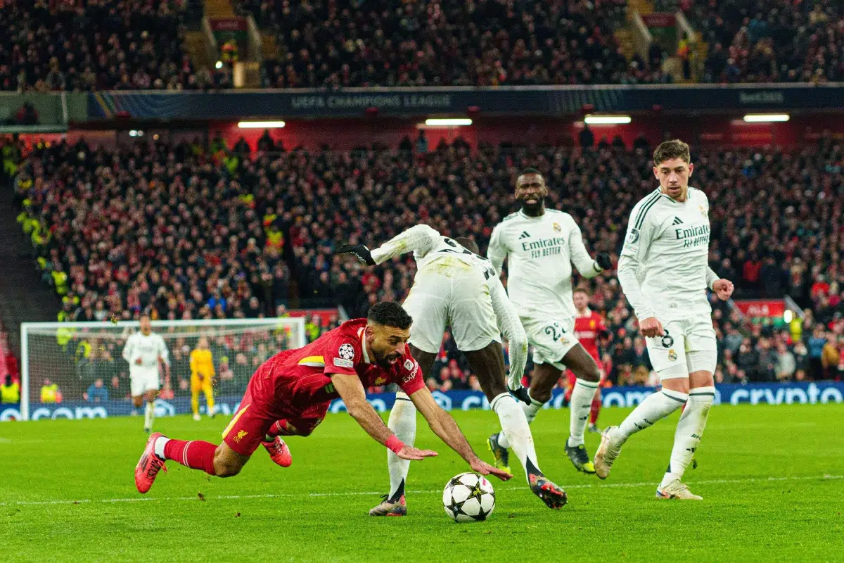 Liverpool's Mohamed Salah goes down after a challenge from Real Madrid's Ferland Mendy, 2024