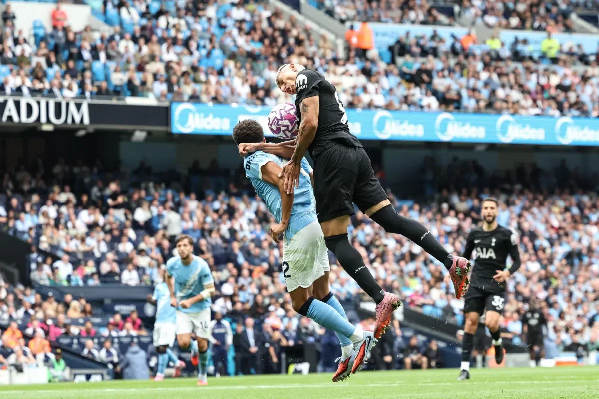 Rico Lewis of Manchester City pressures Richarlison of Tottenham Hotspur, 2025