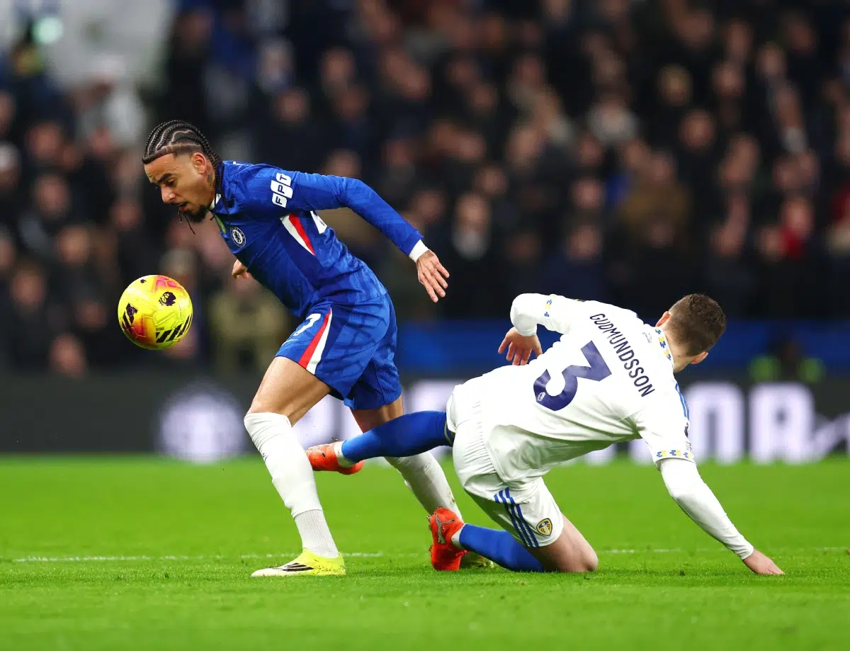 Malo Gusto of Chelsea tackled by Gabriel Gudmundsson of Leeds United, 2026